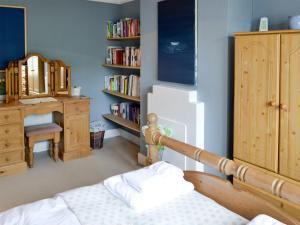 a bedroom with a bed and a book shelf at Pax in St Margarets at Cliff