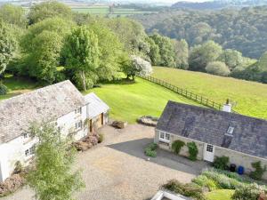 an aerial view of a white house with a field at Cych Cottage in Capel-Ifan