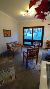 a living room with two chairs and a couch at Parcel do Gostoso Pousada in São Miguel do Gostoso