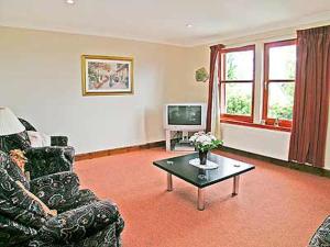 a living room with a couch and a coffee table at 5 Milnamair in Montrose