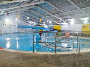 a large swimming pool with a water slide at Happys in St Ives
