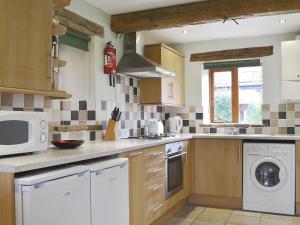 a kitchen with a washer and dryer on the counter at Chive - E4326 in Ludham