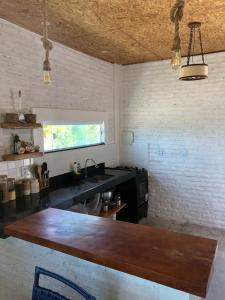 a kitchen with a counter top and a sink at Chalé MAAR in Itarema