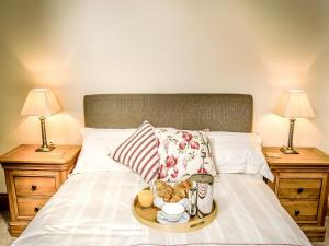 a tray of food on a bed with two lamps at The Farmhouse At Gradbach in Flash