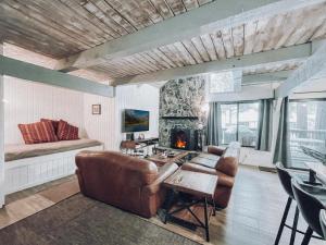 a living room with a couch and a fireplace at Remodeled Home at Snow Summit in Big Bear Lake
