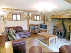 a living room with a couch and a fireplace at The Old Stables in Crynant