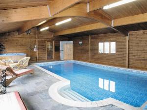 a large swimming pool in a building at The Old Stables in Crynant