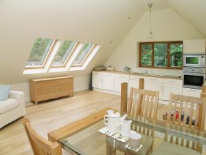 a kitchen and living room with a glass table at Wadadli Lodge in Wrangaton