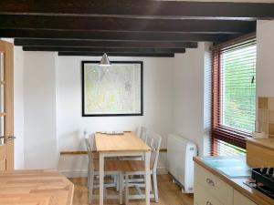 a kitchen with a table and chairs in a room at Rock Cottage in Crosthwaite