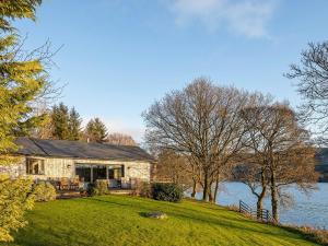 a stone house on the shore of a lake at Carsaig in Port of Menteith