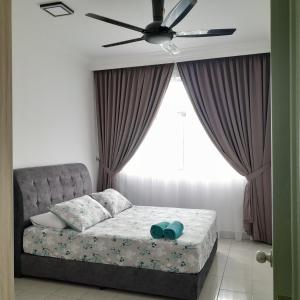 a bedroom with a bed with a ceiling fan at Dlake Putrajaya Homestay in Putrajaya