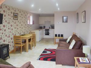 a living room with a couch and a kitchen at Valley View - 29530 in Scotforth