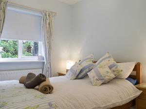 a bed with a stuffed animal on it in a bedroom at Bards Well in Stratford-upon-Avon