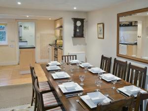 a dining room with a wooden table and chairs at Varley House in Saxmundham