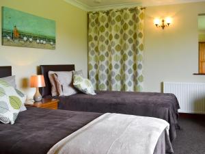 a hotel room with two beds and a window at The Lodge in Brandesburton