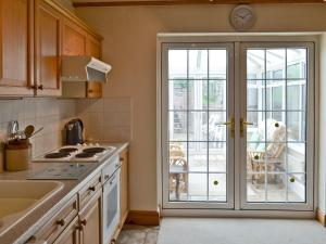 a kitchen with a door leading to a patio at No 2 Flowery Bank in Malton