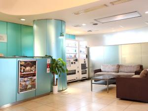 a living room with a refrigerator and a couch at HOTEL LiVEMAX BUDGET Korakuen in Tokyo