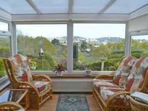 a room with two chairs and a large window at The Lookout in Torquay