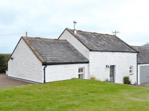 a white house with a black roof at The Steading At Nabny in Dundrennan