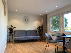 a living room with a blue couch and a table at Luxurious villa with free parking in Gothenburg