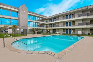 a swimming pool in front of a building at Studio 6-San Antonio, TX - Airport in San Antonio