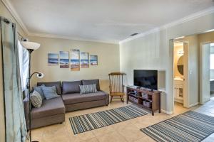 a living room with a couch and a television at Walk to Beach and Dining Sunny St Pete Condo! in St Pete Beach