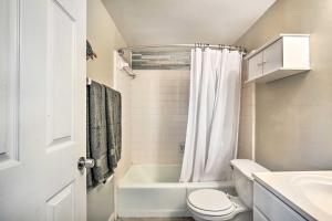 a bathroom with a tub and a toilet and a sink at Walk to Beach and Dining Sunny St Pete Condo! in St Pete Beach +16 photos