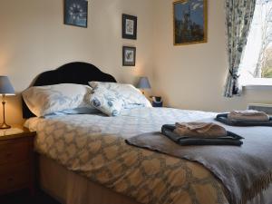 a bedroom with a bed with two towels on it at Ferry View in Oban