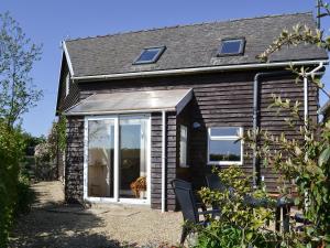 a cottage with a large sliding glass door at Dale View Barn in Lusby