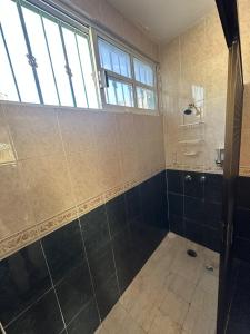 a bathroom with a shower and a window at Viento Casa los 4 elementos in Cancún