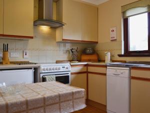 a kitchen with a stove and a counter top at Duart in Onich