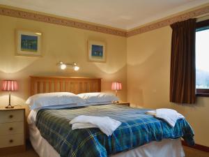 a bedroom with a bed with two pillows at Duart in Onich