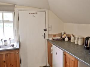 a kitchen with a sink and a white door at The Old Post Office in Fordingbridge