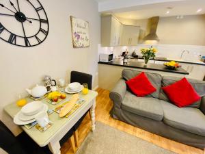 a living room with a couch and a table with red pillows at The Stable - 28356 in Corbridge