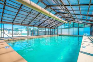 a large indoor swimming pool with blue water at Relaxation Pointe in Branson