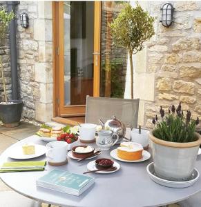 a table with plates of food on top of it at The Little Barn @ Bath With LARGE Hot Tub in Bath