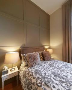 a bedroom with a bed with a headboard and a lamp at The Little Barn @ Bath With LARGE Hot Tub in Bath