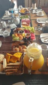 a table topped with lots of different types of breakfast foods at El Refugio de Santa Cruz in Santa Cruz