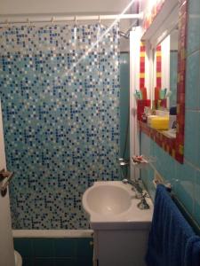 a bathroom with a sink and a shower at Departamento Isabel II in Mar del Plata