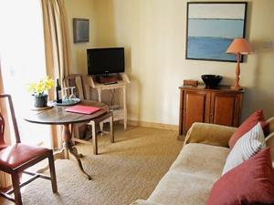 a living room with a couch and a table at Stepping Gate Cottage in Scalby