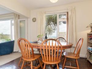 a dining room with a wooden table and chairs at Gorwel Glas in Fishguard