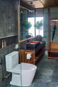 a bathroom with a toilet and a sink at NANO ECO-HOSTEL in Hue