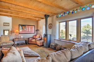a living room with a couch and a fireplace at Family-Friendly Del Norte Home with Stunning Views! in Del Norte
