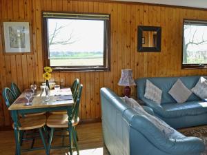 a living room with a couch and a table at Finch Lodge - E4793 in Nawton