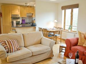 a living room with a couch and a kitchen at Church View - 24731 in Bearsted