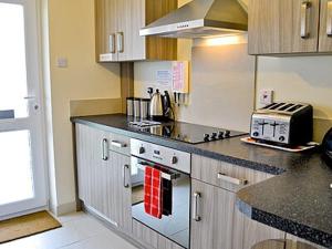 a kitchen with a stove and a counter top at Blue Waves in Perranporth