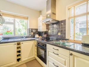 a kitchen with a sink and a stove at Harrys Den in Alnwick