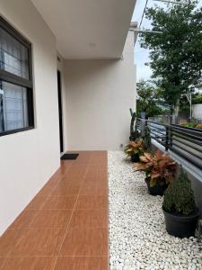 a walkway in the side of a house with plants at The Pines Smart Homes in Batu +6 photos