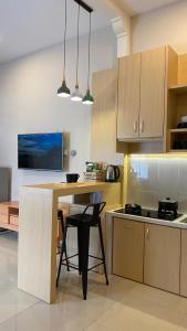 eine Küche mit einem Holztisch und einer Arbeitsplatte in der Unterkunft The Pines Smart Homes in Batu