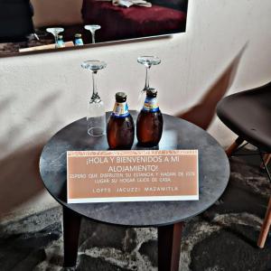 duas garrafas numa mesa com um cartaz em No. 2 Encantador Loft Jacuzzi Mazamitla em Mazamitla